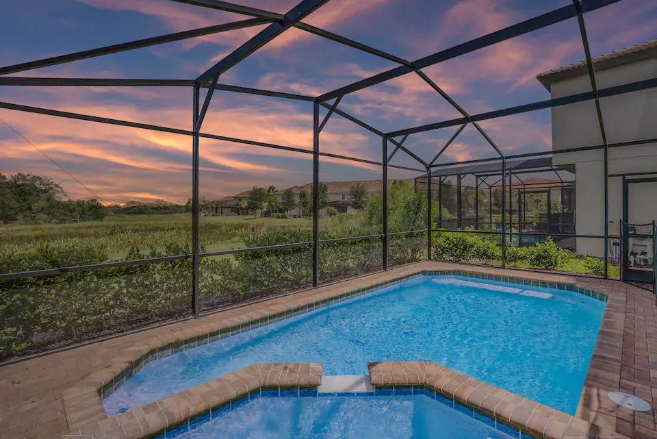 A view at the pool in an open surrounding during the sunset