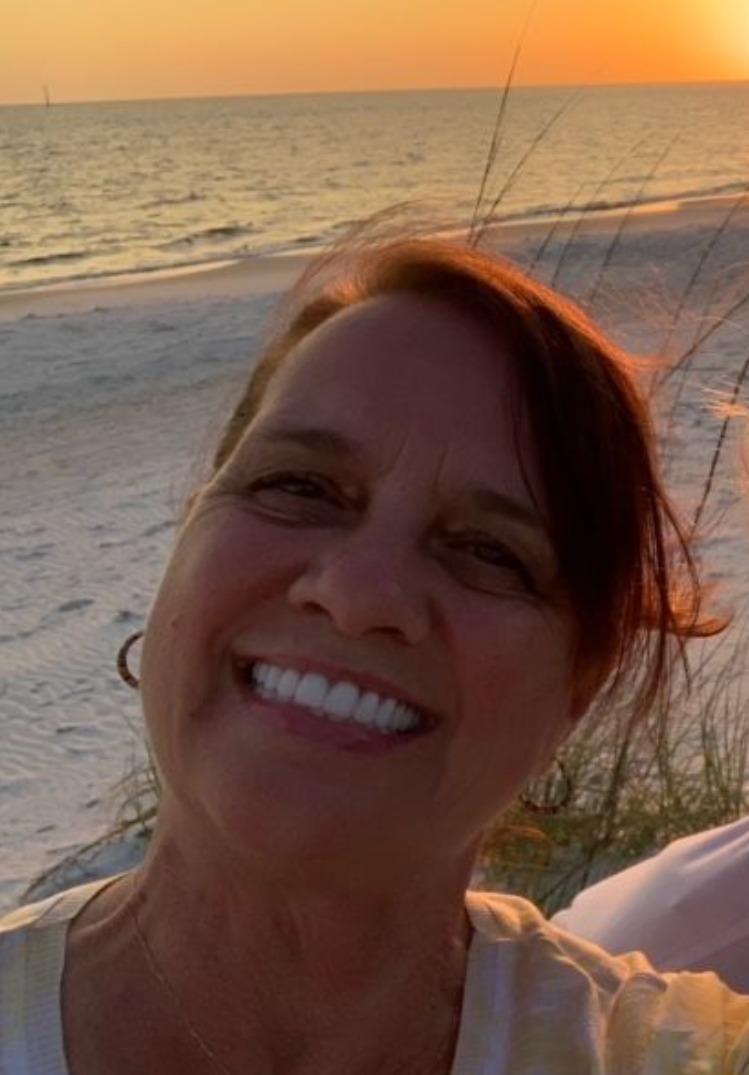 closeup of brunette woman smiling at camera