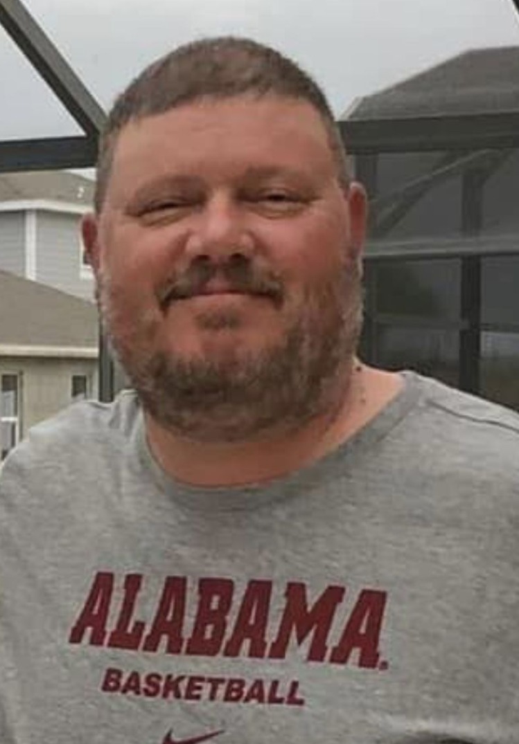 man wearing grey alabama basketball shirt